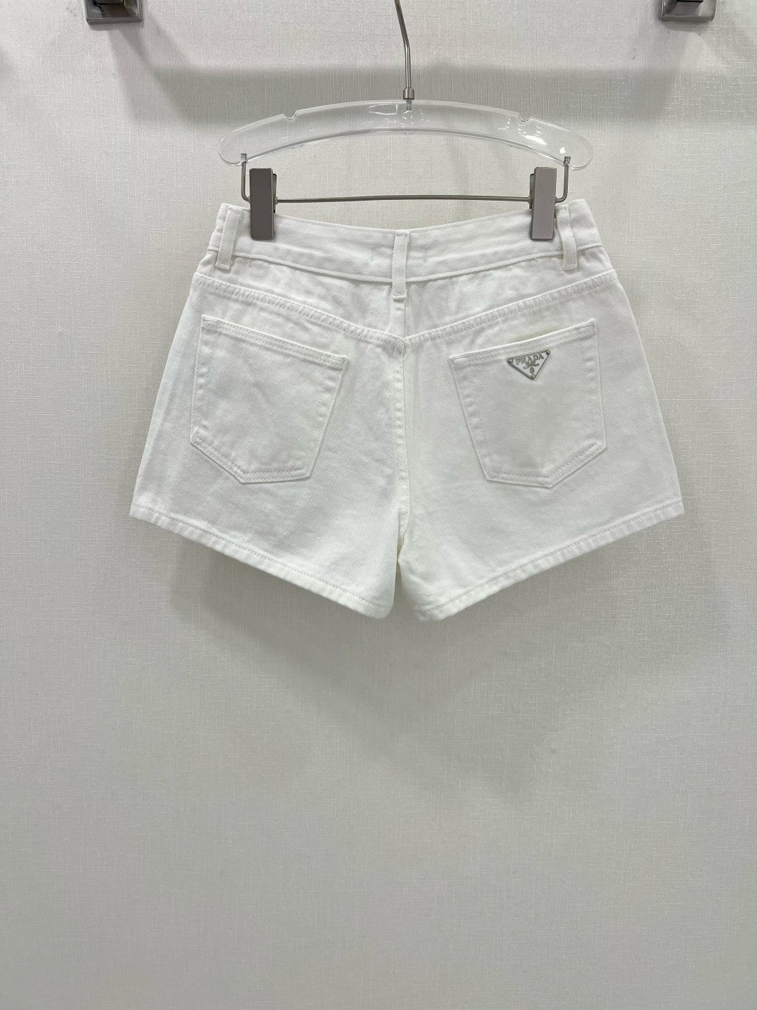 White jeans with classic triangle logo